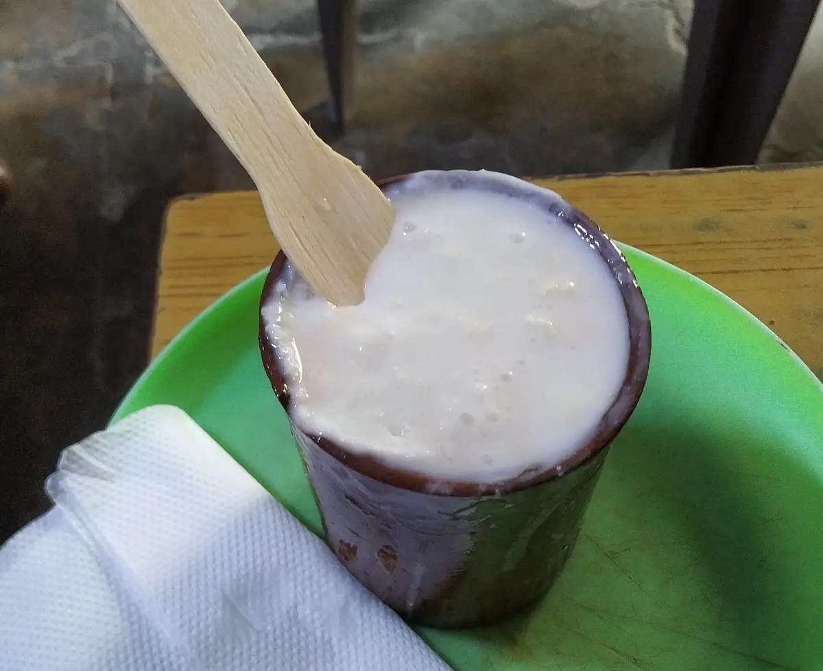 A glass of lassi topped with cream